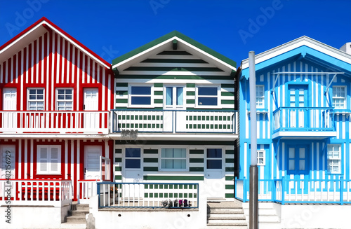 Colorful striped wooden beach houses at the promenade of Costa Nova, Aveiro, Portugal