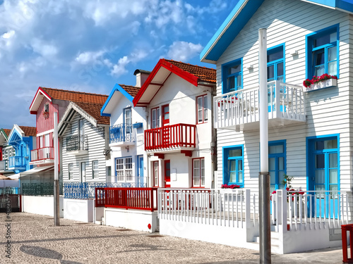Colorful striped wooden beach houses at the promenade of Costa Nova, Aveiro, Portugal