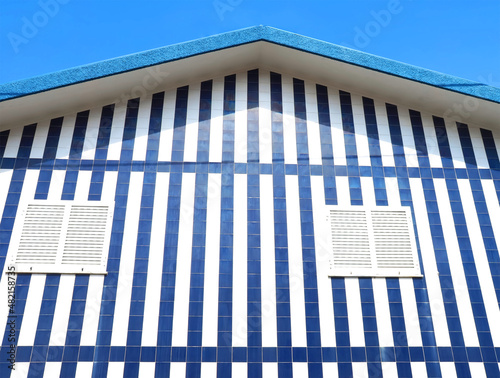 Colorful striped wooden beach houses at the promenade of Costa Nova, Aveiro, Portugal
