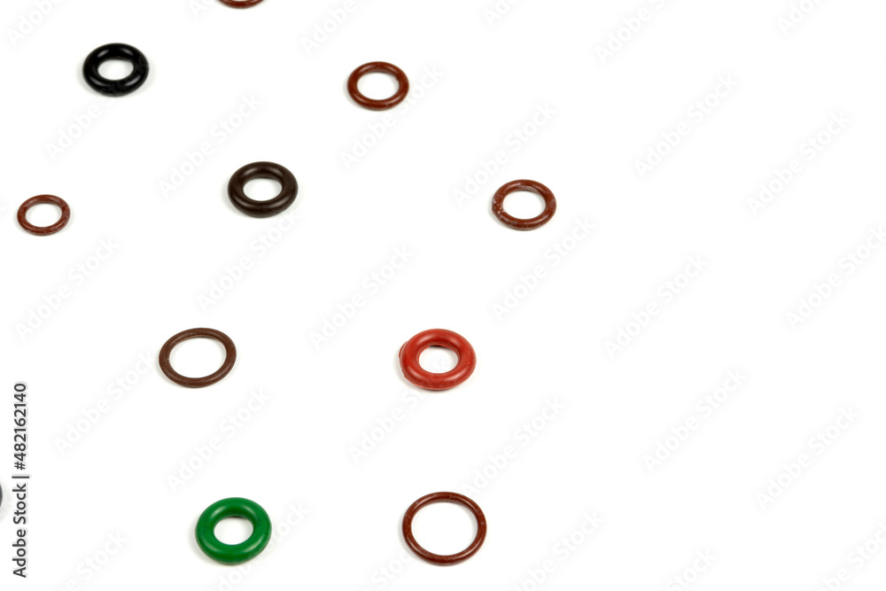 Background of sealing rings and gaskets of different colors on a white background . Hydraulic and pneumatic o-rings in different sizes on a white background.