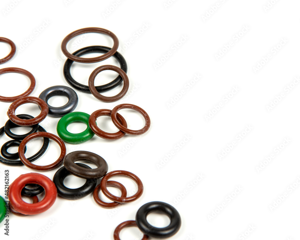 Hydraulic and pneumatic o-rings in different sizes and colors, on a white background. Various seals for plumbing. Sealing rings for hydraulic connections. Hydraulic and pneumatic o-rings in different sizes and colors, on a white background. Various seals for plumbing. Sealing rings for hydraulic connections.