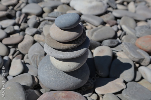 The stones on the sea beach are in the form of a slide.  