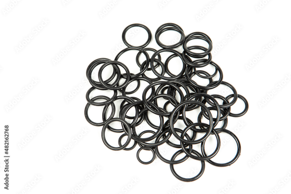 Hydraulic and pneumatic o-rings in black in different sizes on a white background. Various seals for plumbing. Sealing rings for hydraulic connections. Hydraulic and pneumatic o-rings in black in different sizes on a white background. Various seals for plumbing. Sealing rings for hydraulic connections.