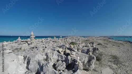 Real-time video panoramic view of stone pyramids in Illetes beach of Formentera island in Spain. High-quality FullHD footage photo