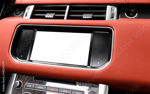 Monitor in car with isolated blank screen use for navigation maps and GPS. Isolated on white with clipping path. Car detailing. Car display with blank screen. Modern car red leather interior