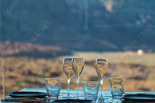 Glass, cup, plates and cuttlery on a wooden table photo