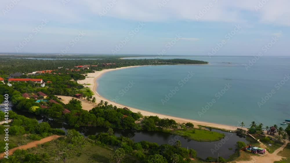 A tropical beach with palm trees and a blue ocean. Sri Lanka. Pasikuda Beach, Sri Lanka. A tropical beach with palm trees and a blue ocean. Sri Lanka. Pasikuda Beach, Sri Lanka.