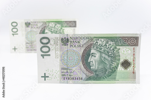 One hundred zloty - Polish banknote. Polish currency on a white background arranged in a pattern. Illustrates cash flow and business