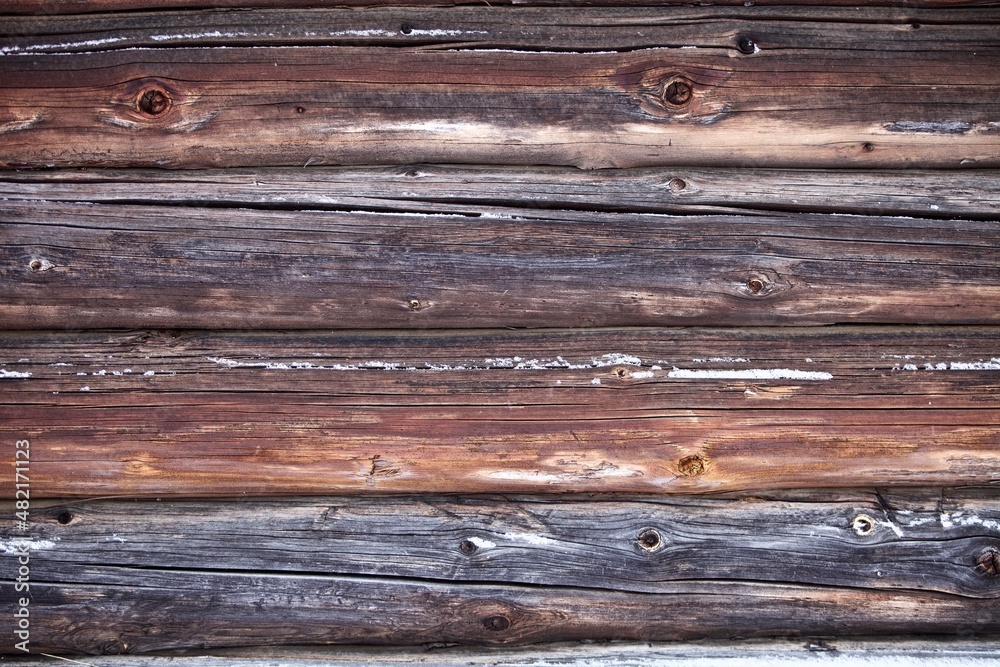 weathered surface of the old wooden log house wall close-up. log walls texture close up. Wooden Log cabin wall in snow close up. The frame of a wooden blockhouse. Vintage log wall surface full frame. weathered surface of the old wooden log house wall close-up. log walls texture close up. Wooden Log cabin wall in snow close up. The frame of a wooden blockhouse. Vintage log wall surface full frame.