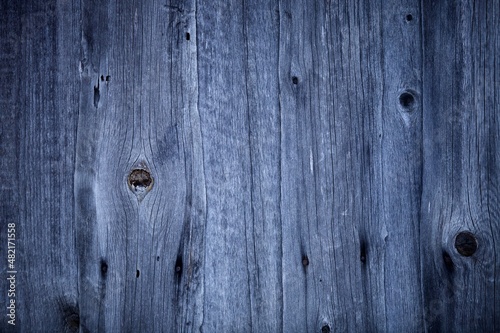 Dark wood boards texture close up. Vintage wooden surface background. Unpainted natural hardwood boards texture. Weathered surface of the old planks of wooden wall close-up. High contrast wood.