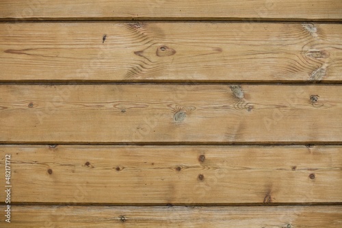 wooden boards texture close up. Vintage wooden surface background. Unpainted natural hardwood boards texture. Weathered surface of the old planks of wooden wall close-up. High contrast wood texture.