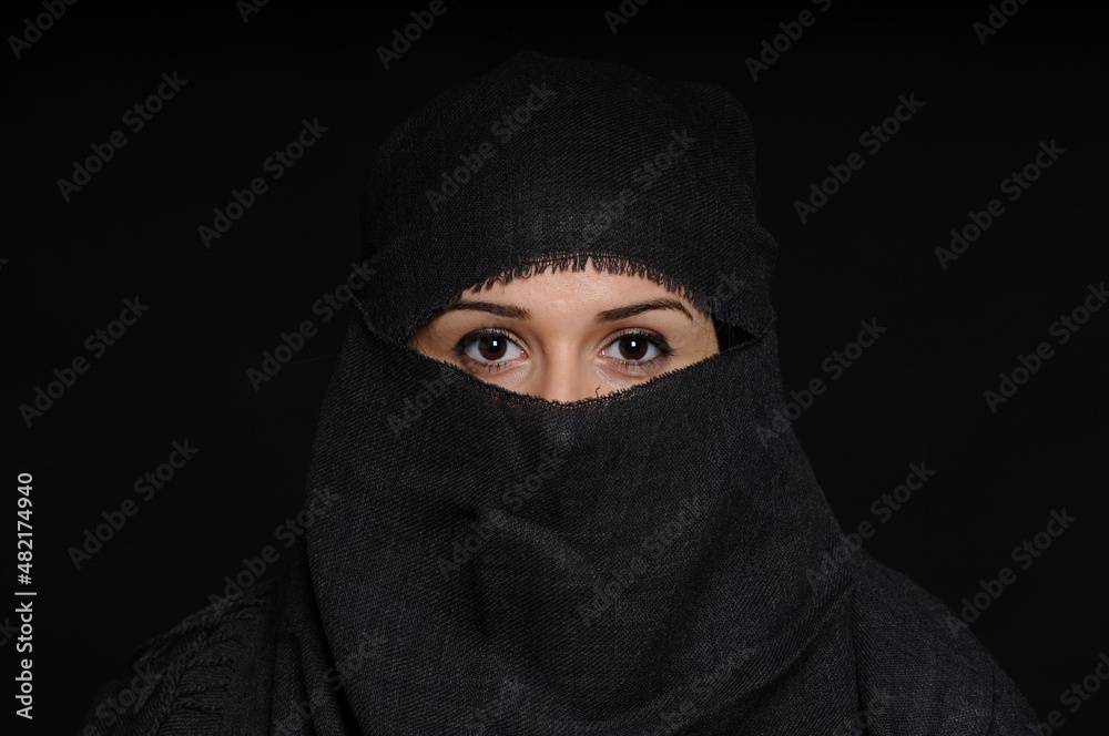 Eastern girl covered her face with a gray scarf
Eastern girl covered her face with a gray scarf