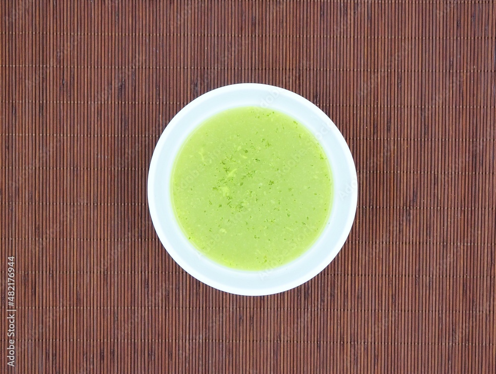 Chervil soup isolated on a wooden background, top view. Chervil soup isolated on a wooden background, top view.