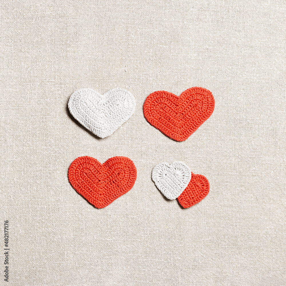 Valentines day concept, knit hearts valentine as creative square pattern, handmade colored crochet heart on cloth table, diy gift for romance holiday, symbol of love. Festive background Valentines day concept, knit hearts valentine as creative square pattern, handmade colored crochet heart on cloth table, diy gift for romance holiday, symbol of love. Festive background