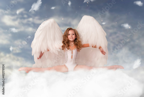 cute charming girl on February 14 Valentine's Day sits in twine gymnast on a cloud with angel wings photo