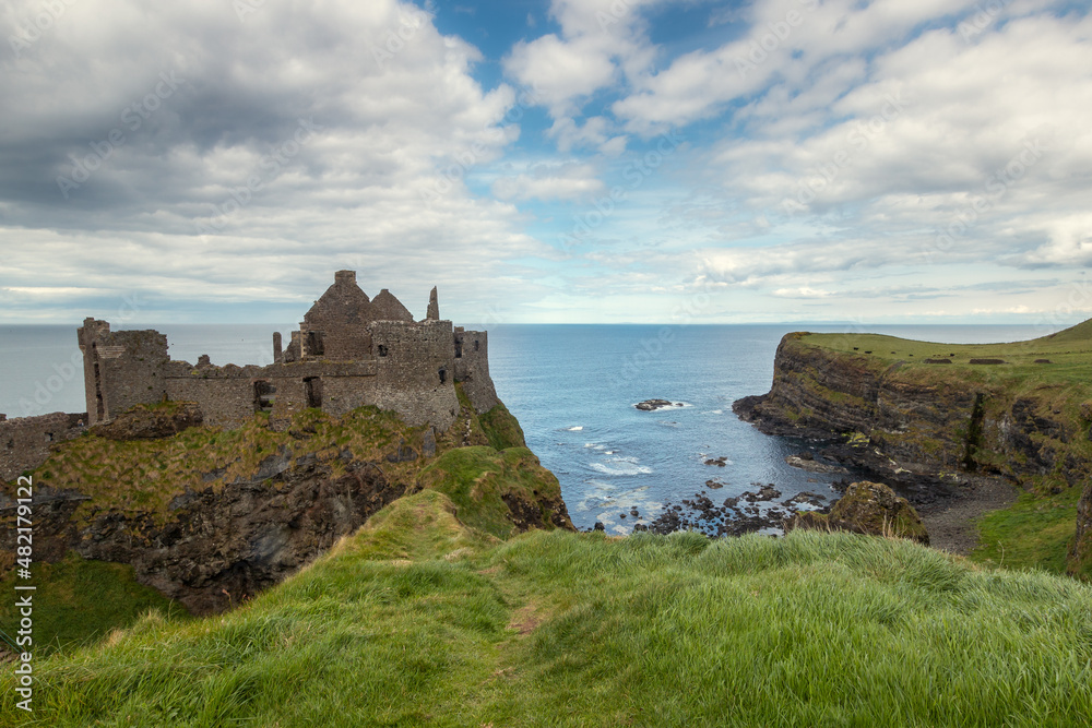 view of Dunluce Castle in Northern Ireland in a cloudy day.  Portrush. United Kingdom