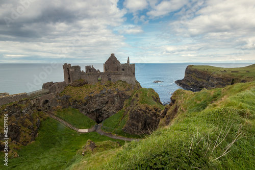 view of Dunluce Castle in Northern Ireland in a cloudy day. Portrush. United Kingdom
