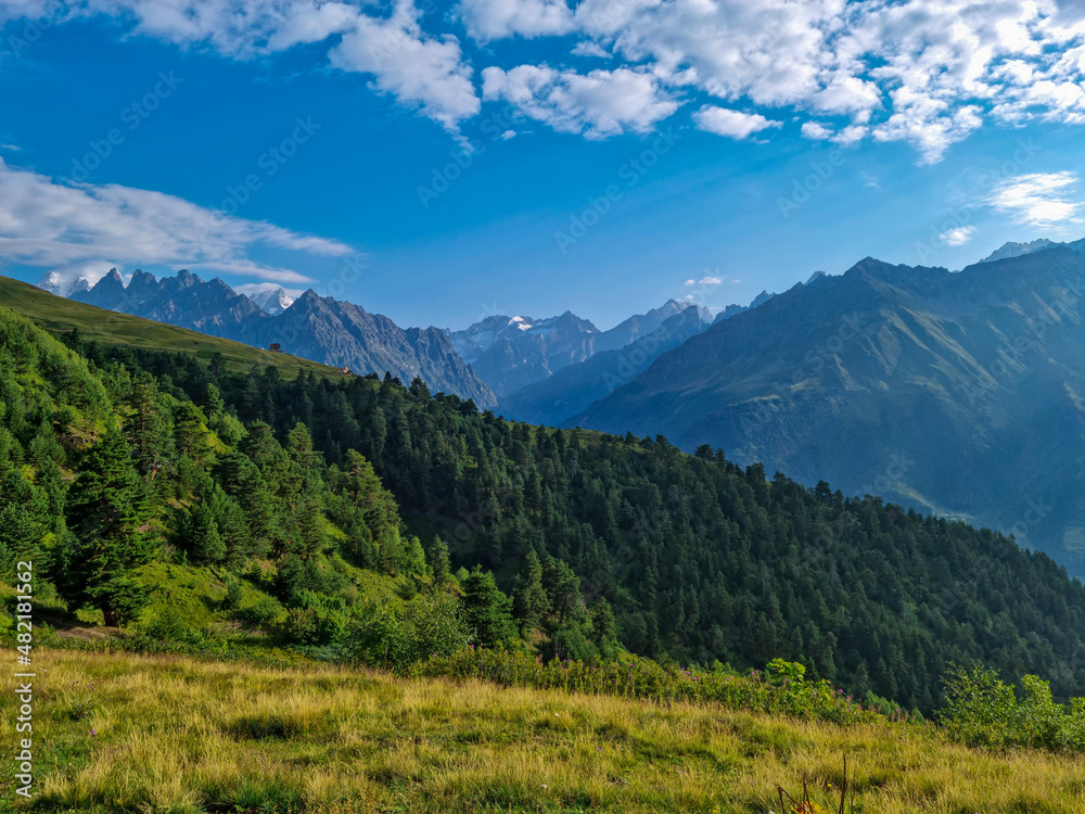 An amazing view on the  Svaneti mountain peaks near Mestia in the Greater Caucasus Mountain Range, Upper Svaneti,Country of Georgia.Hiking trail to the Koruldi Lakes. Dense forest. Cottage,hut