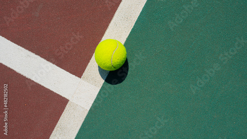 Wallpaper Mural Yellow tennis ball lying on line of the red and green court. Flat lay view. Space for text Torontodigital.ca