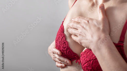 Middle aged caucasian woman doing breast self examination