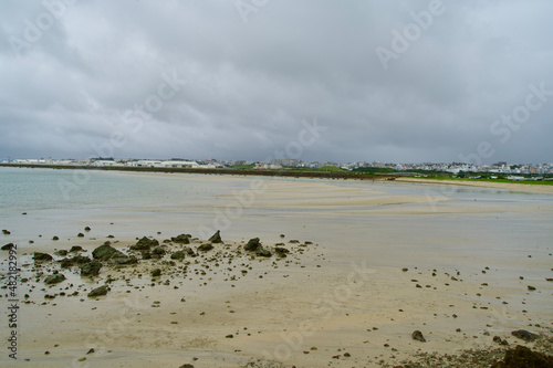 Some rough stones on the beach on rainy day.