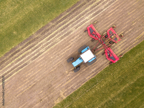 Aerial top down drone photo. Agriculture tractor with seeding irrigation system on parking. Russia.