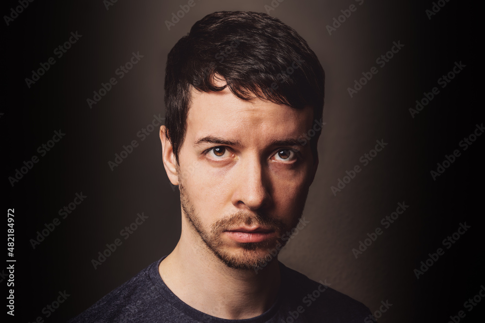 Young man looking at camera with negative emotion Young man looking at camera with negative emotion