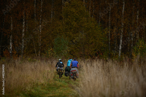 Russian bicyclists in the autumn forest  Moscow Region
