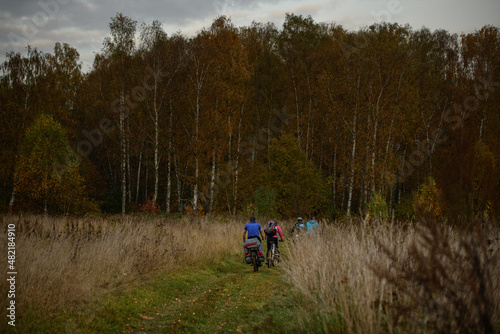 Russian bicyclists in the autumn forest, Moscow Region