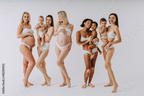 Beauty shot of beautiful pregnant women and mothers holding babies, motherhood and pregnancy concept