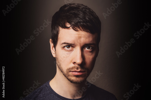 Young man looking at camera with negative emotion