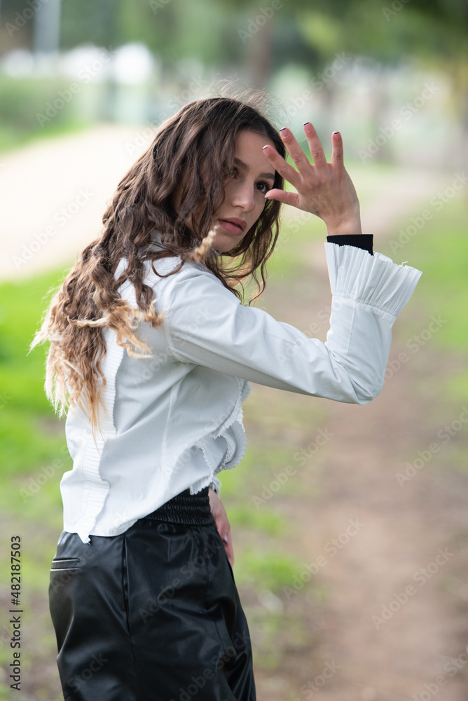 Young woman dancing outdoors. Dance performance in the street Young woman dancing outdoors. Dance performance in the street