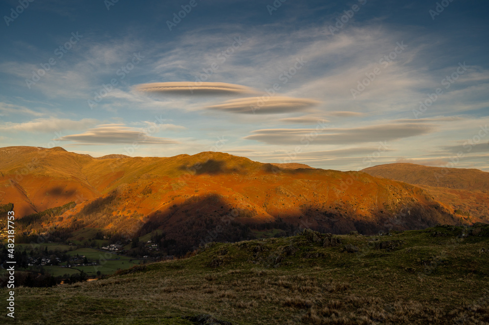 Lenticular clouds above fells in the English Lake District Lenticular clouds above fells in the English Lake District