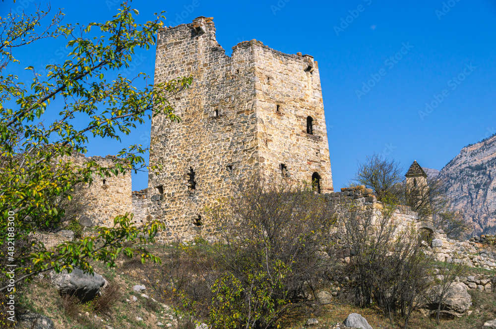 An abandoned medieval town. A complex of towers in the mountains of Ingushetia. Military and residential ancient towers built of stones. Landscape in the mountains with a view of the ruins.