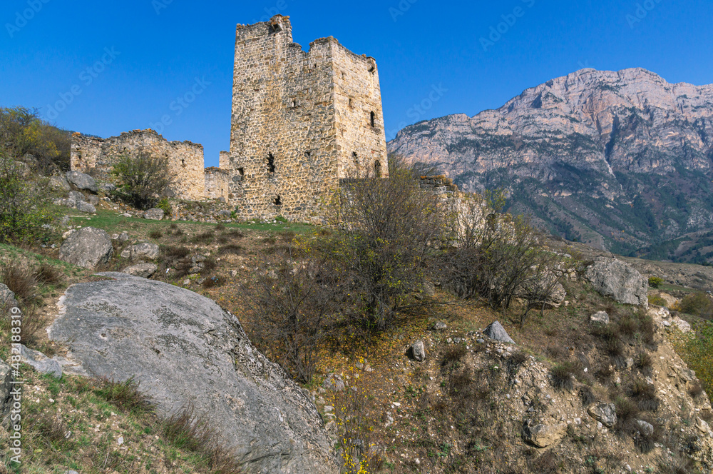 An abandoned medieval town. A complex of towers in the mountains of Ingushetia. Military and residential ancient towers built of stones. Landscape in the mountains with a view of the ruins.