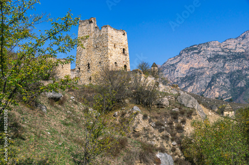 An abandoned medieval town. A complex of towers in the mountains of Ingushetia. Military and residential ancient towers built of stones. Landscape in the mountains with a view of the ruins.