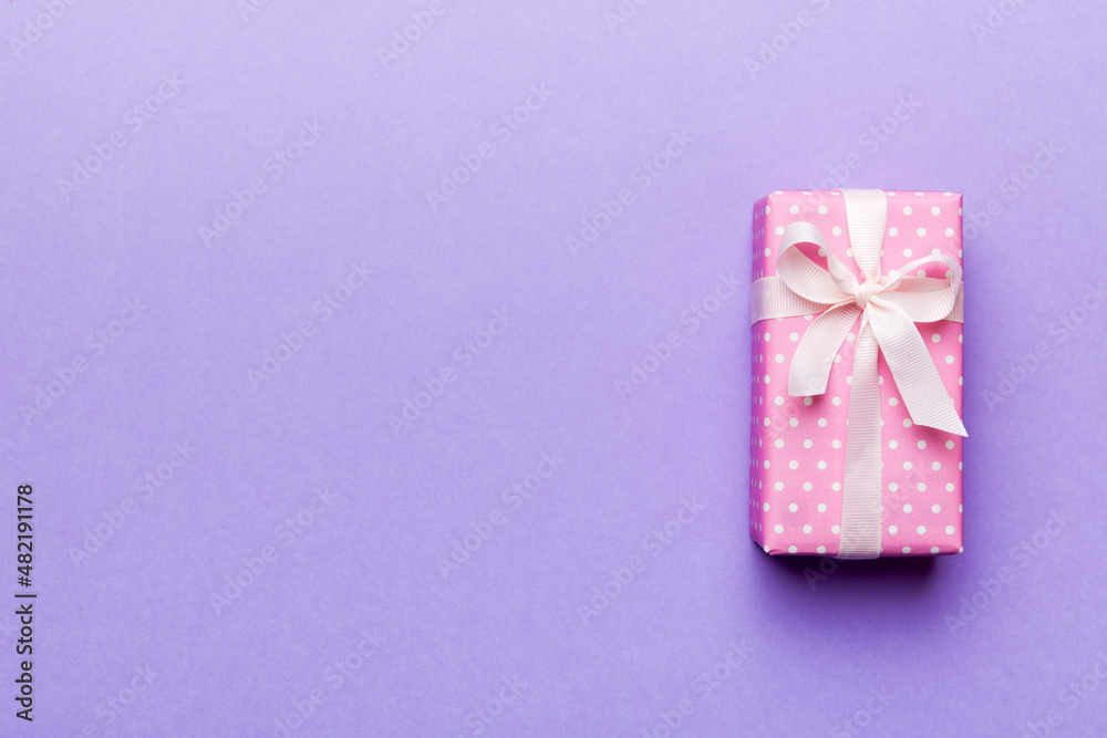 Valentine day composition: red gift box with bow and heart. Christmas present. View from above. Space for text. Holday greeting card Valentine day composition: red gift box with bow and heart. Christmas present. View from above. Space for text. Holday greeting card