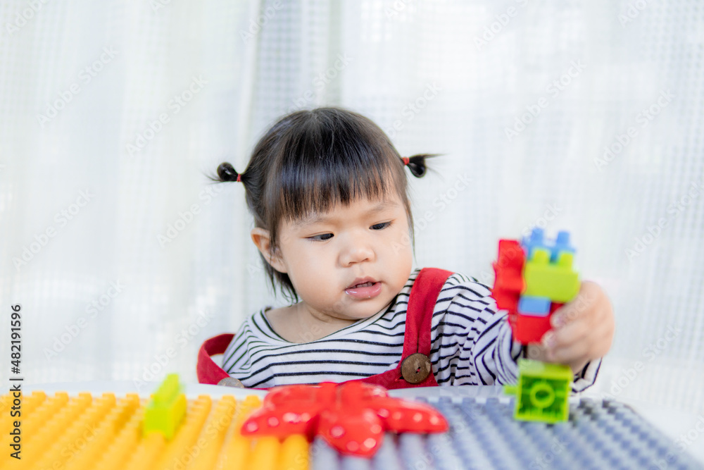 Happy little girl playing with the developmental toys, Asian girl, cute kid. Happy little girl playing with the developmental toys, Asian girl, cute kid.