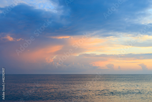 the sky is blue and pink during sunset on the sea