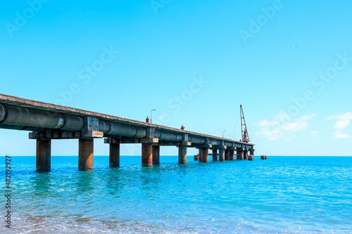 pier on the sea coast in daylight  blue sea and blue sky