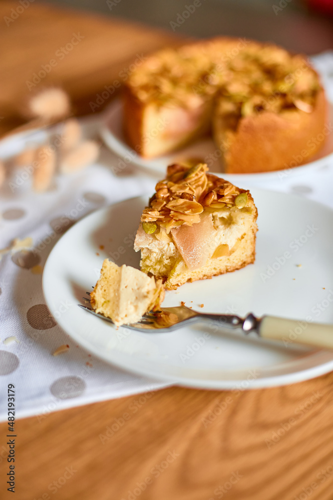 Piece of apple or pear pie, tart with caramel nuts on wooden table, copy space, top view. Piece of apple or pear pie, tart with caramel nuts on wooden table, copy space, top view.