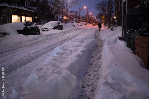 Toronto, Ontario / Canada - January 17, 2022 - Person walking in Toronto St Clair West on day of snowstorm