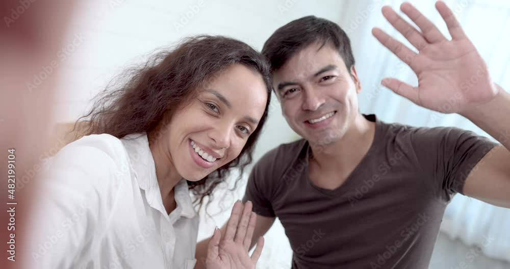 Smiling romantic couple taking selfies with online video calls on smartphones. Smiling romantic couple taking selfies with online video calls on smartphones.