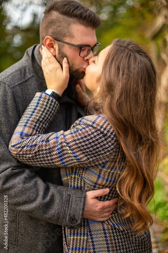 White young european married couple portrait kissing outside