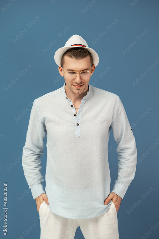 Half length of hipster man who posing in modern eyewear with elegant hat on colorful background Half length of hipster man who posing in modern eyewear with elegant hat on colorful background