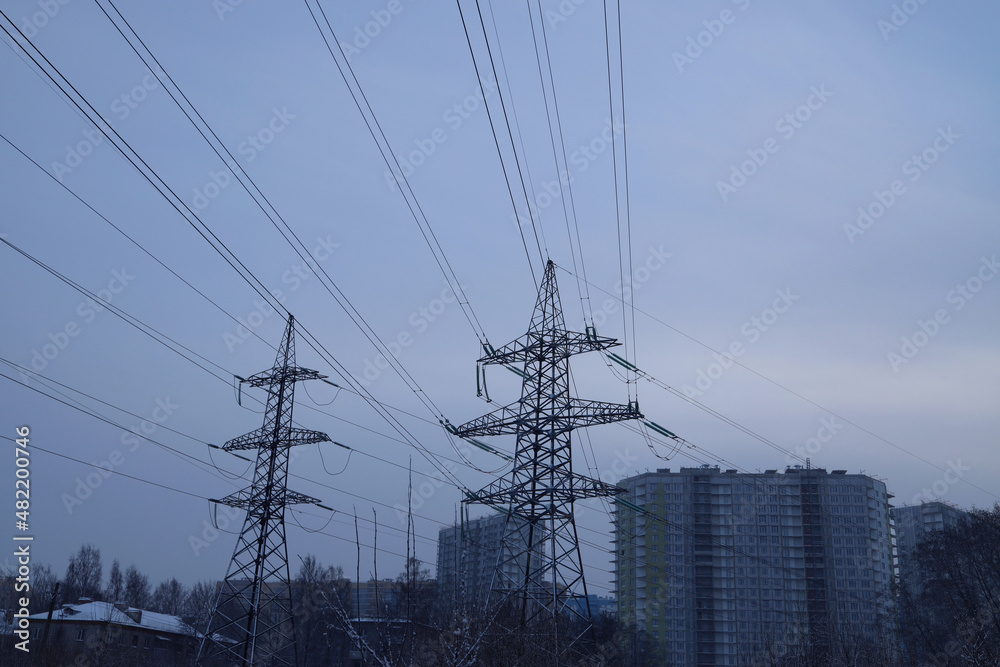 The power tower. Power lines in the city on a winter evening.