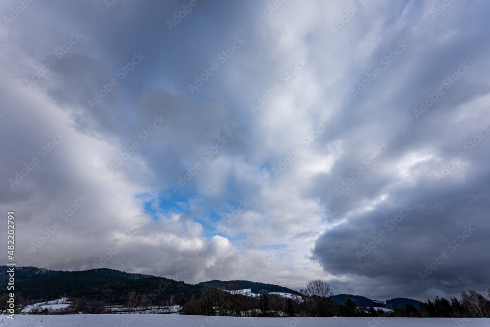 Horizon with dark dramatic sky and clouds in winter.