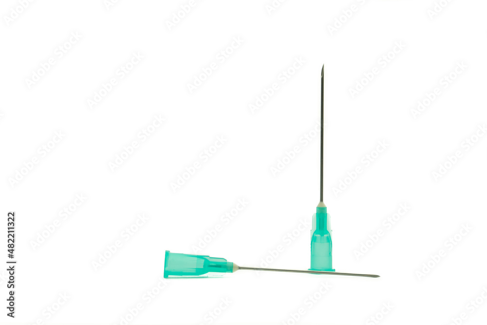 Horizontal photo with a pure white background of two medical syringe needles with a light green base and a dark metallic needle, one in a vertical position and the other lying down. Horizontal photo with a pure white background of two medical syringe needles with a light green base and a dark metallic needle, one in a vertical position and the other lying down.
