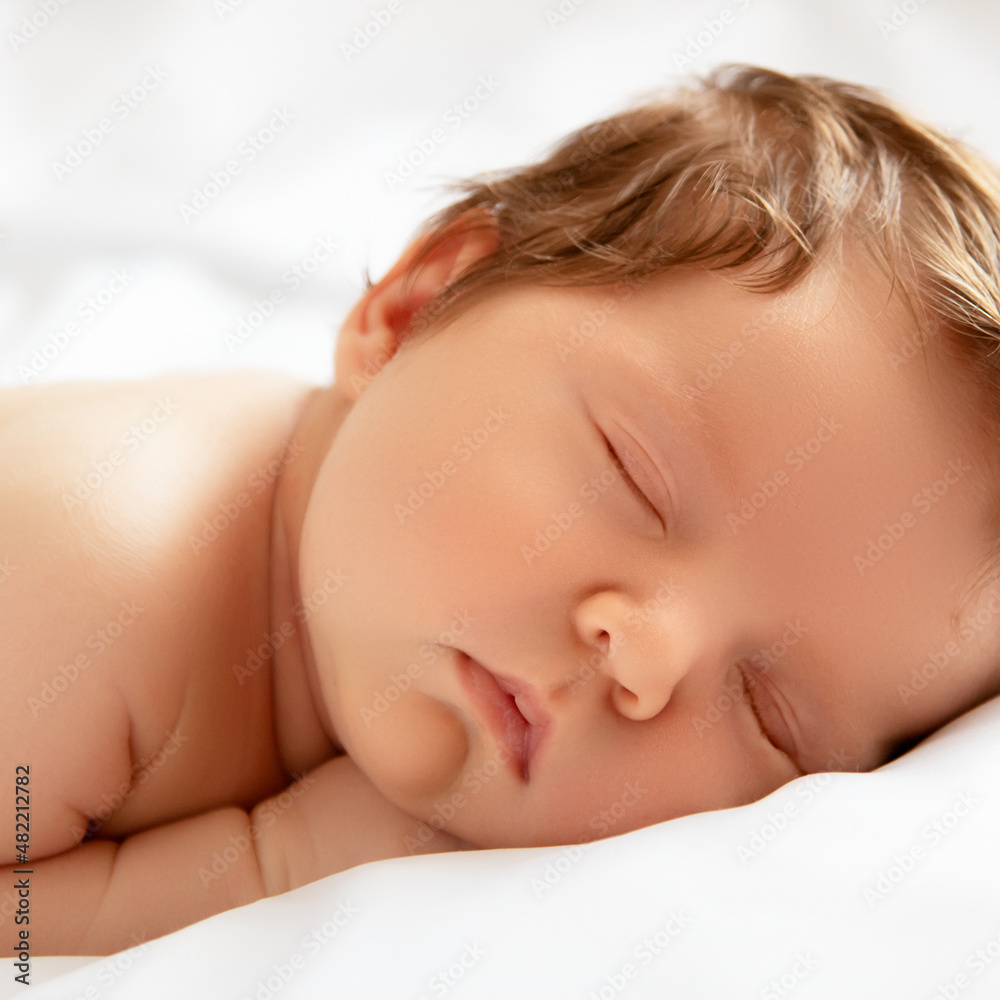 A Baby girl with Smily Face During Sleep. Little baby girl sleeping on white blanket. Beautiful portrait of little child girl 14 days, two weeks old. Motherhood A Baby girl with Smily Face During Sleep. Little baby girl sleeping on white blanket. Beautiful portrait of little child girl 14 days, two weeks old. Motherhood