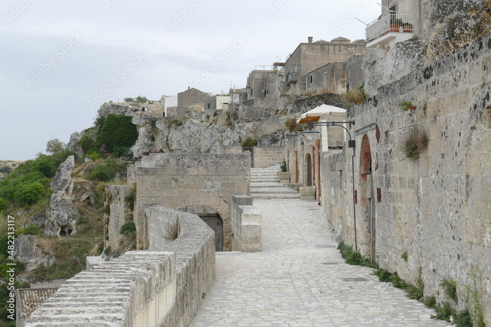 typical street of Sasso Caveoso in Matera with the facade of rupestrian houses built by white sandstone